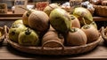 Fresh green and brown coconuts in wicker basket on rustic wooden market stall display Royalty Free Stock Photo