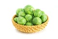 Fresh green brussel sprouts vegetable in a basket on white background Royalty Free Stock Photo