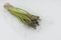 Fresh green bunch of asparagus in a plastic bag