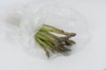 Fresh green bunch of asparagus in a plastic bag