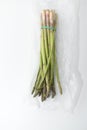 Fresh green bunch of asparagus in a plastic bag Royalty Free Stock Photo