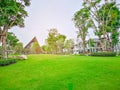 Fresh green Burmuda grass smooth lawn as a carpet with curve form of bush, trees on the background, good maintenance landscapes Royalty Free Stock Photo