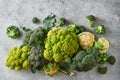 Fresh green cabbage, cauliflower and broccoli on a light textured background