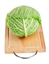 Fresh green cabbage head on wooden chopping board Royalty Free Stock Photo