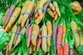 Fresh green cabbage, rainbow carrots and spinach in rubber bands at food store in America Royalty Free Stock Photo