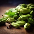 Fresh green cardamom pods on a wooden background - selective focus