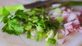 Celery leaves with shredded shallots on cutting board Royalty Free Stock Photo