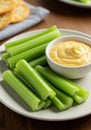 Fresh Green Celery Sticks with Creamy Yellow Dip Royalty Free Stock Photo