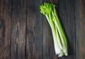 Fresh green celery vegetable on wood. Top view. Organic background