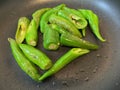 fresh green chilis was cut in half and fried with vegetable olive oil in non stick pan Royalty Free Stock Photo