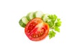 Fresh green chopped cucumber and red tomato, parsley, ripe vegetables, salad ingredient, isolated on white background Royalty Free Stock Photo