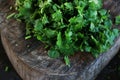 Fresh green cilantro, coriander leaves with slice on wooden surface Royalty Free Stock Photo