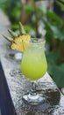 fresh green cocktail with pineapple garnish Royalty Free Stock Photo