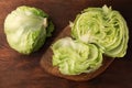 Fresh green cut and whole iceberg lettuce heads on wooden table, flat lay