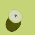 Fresh Green Cutted Apple isolated on green background Royalty Free Stock Photo