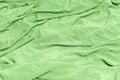 Fresh green fabric texture with soft drapery Royalty Free Stock Photo