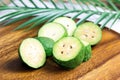 Fresh green feijoa pineapple guava fruit slices on brown wooden background in the kitchen. Royalty Free Stock Photo