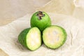 Fresh green feijoa pineapple guava fruit slices on light background in the kitchen. Royalty Free Stock Photo