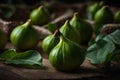Fresh green figs with leaves on rustic wooden background