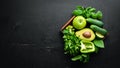 Fresh Green Fruits and Vegetables. Pure selection and source of vegetable protein on a wooden aged background. Royalty Free Stock Photo