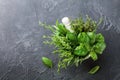 Fresh green garden herbs in mortar bowl on black stone table top view. Thyme, rosemary, basil, and tarragon for cooking. Royalty Free Stock Photo