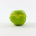 Fresh green apple with a symbol of a cut heart on the front, isolated on a white background Royalty Free Stock Photo