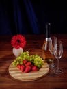 Fresh green grapes and red strawberry on a wooden board, Royalty Free Stock Photo