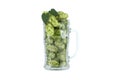 Hops in glass beer mug over white background Royalty Free Stock Photo