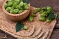 Fresh green hops and ears of wheat on wooden table Royalty Free Stock Photo