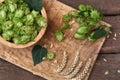 Fresh green hops and ears of wheat on wooden table, flat lay Royalty Free Stock Photo