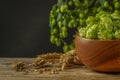 Fresh green hops, wheat grains and spikes on wooden table, closeup. Space for text Royalty Free Stock Photo