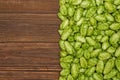 Fresh green hops on a wooden background. Ingredient for beer production. Top view with copy space Royalty Free Stock Photo