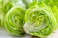 Fresh green iceberg lettuce salad leaves cut on light background on the table in the kitchen. Royalty Free Stock Photo