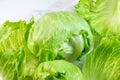 Fresh green iceberg lettuce salad leaves cut on light background on the table in the kitchen. Royalty Free Stock Photo