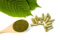 Fresh green Kratom leaves and natural herbal medicine powder capsule Royalty Free Stock Photo