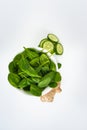 Fresh green leaves spinach, slices of cucumber and ginger isolated on a white background. Copy space for text. Healthy