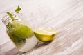 Sparkling water with fresh green lemons and mint in a jar