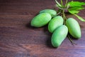 Fresh green mango fruit on a wooden table. Royalty Free Stock Photo