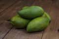 Fresh green mango on wooden table. Tropical fruit. mangoes on wooden background Royalty Free Stock Photo
