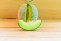 Fresh green melon on wood plate