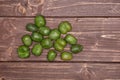 Fresh green mini baby kiwi fruit on brown wood Royalty Free Stock Photo