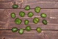 Fresh green mini baby kiwi fruit on brown wood Royalty Free Stock Photo