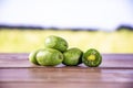 Fresh green mini baby kiwi fruit with field behind Royalty Free Stock Photo