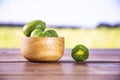 Fresh green mini baby kiwi fruit with field behind Royalty Free Stock Photo