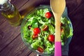 Fresh green mixed salad in a bowl on a dark wooden table. Concept healthy lifestyle and simple food Royalty Free Stock Photo