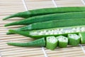 Fresh green okra with bamboo mat