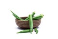 Fresh green okra in a separate wooden bowl