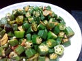 Fresh green okra stir fry in white plate