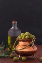 Fresh green olives on the wooden background. Vertical orientation Royalty Free Stock Photo