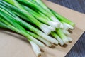 Fresh green onion closeup on wooden table